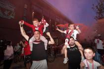 Liverpool supporters celebrate as they gather outside of Anfield Stadium in Liverpool, England, ...