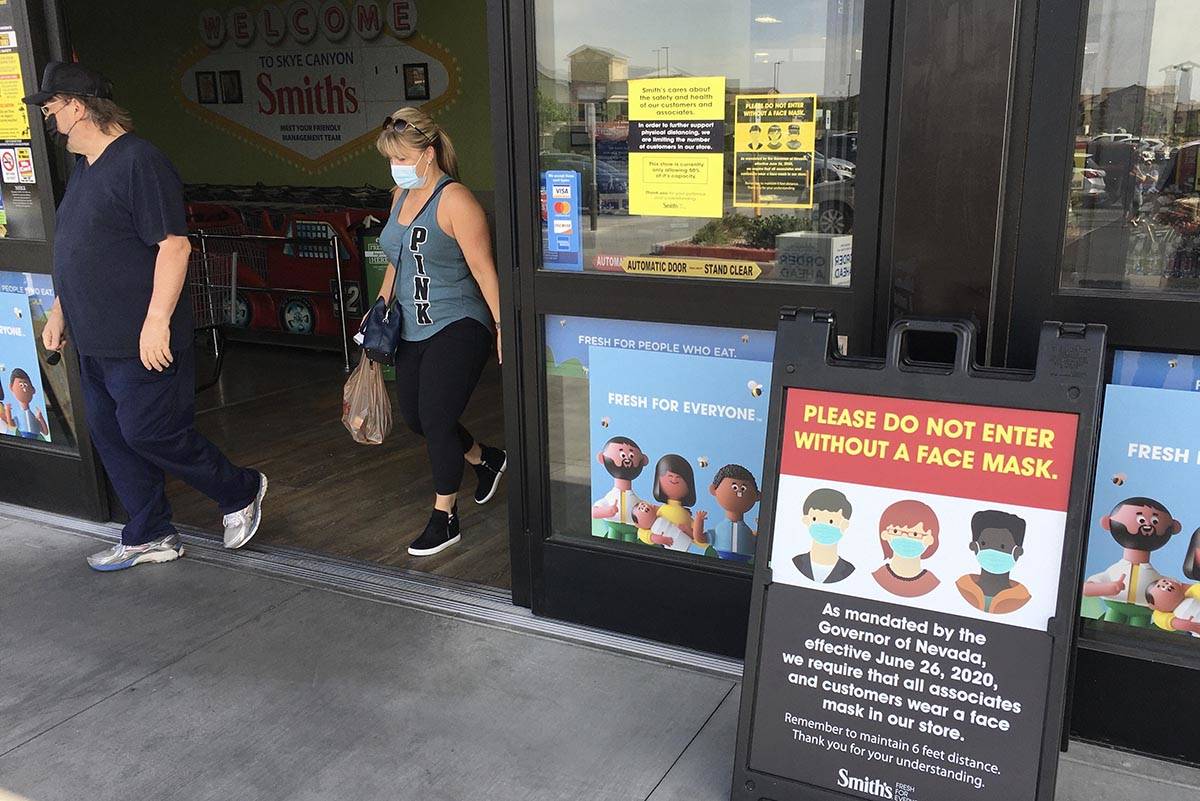 A sign informs people to wear a mask before entering the Smith’s Marketplace on Skye Canyon P ...