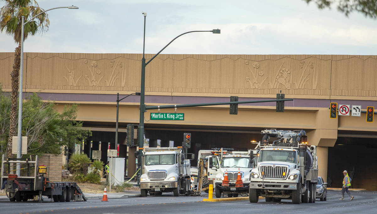 Las Vegas Valley Water District workers repair a sinkhole which opened up and damaged vehicles ...