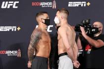 UFC lightweight Dustin Poirier, left, faces off against his opponent, Dan Hooker, right, at the ...