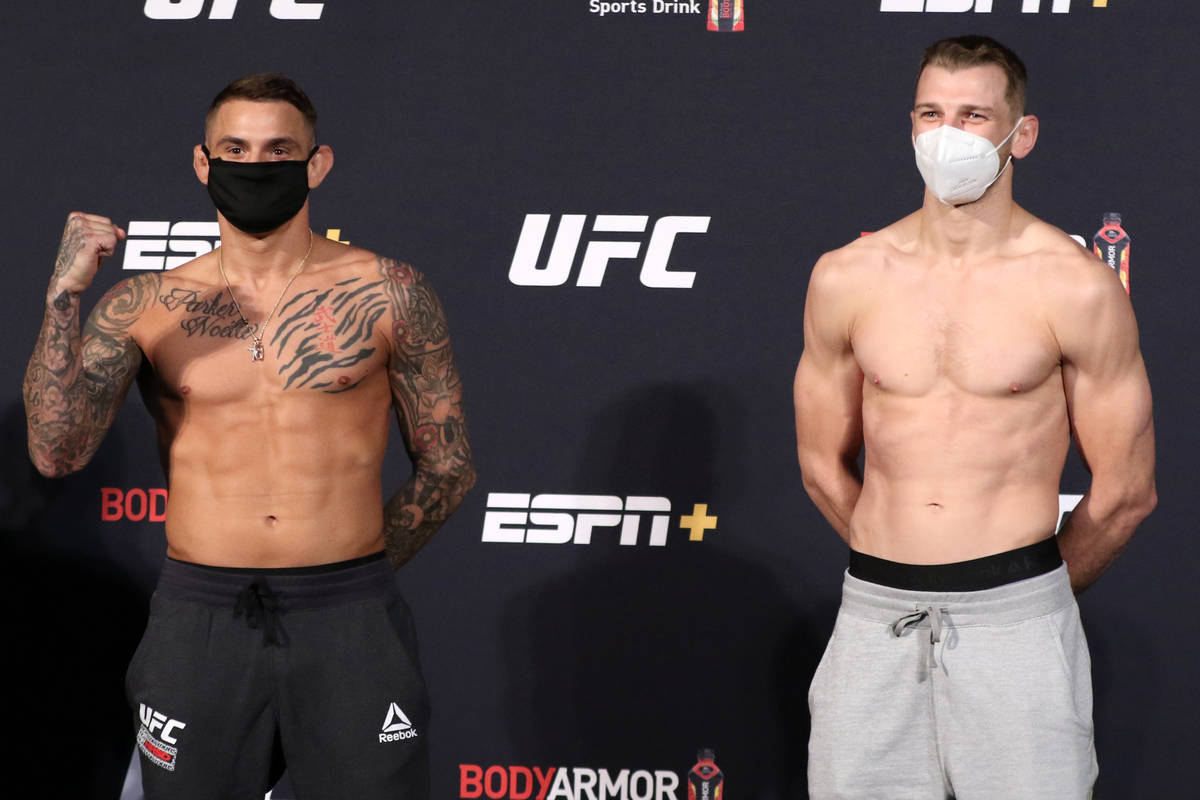 UFC lightweight Dustin Poirier, left, poses opposite his opponent, Dan Hooker at the UFC Apex d ...