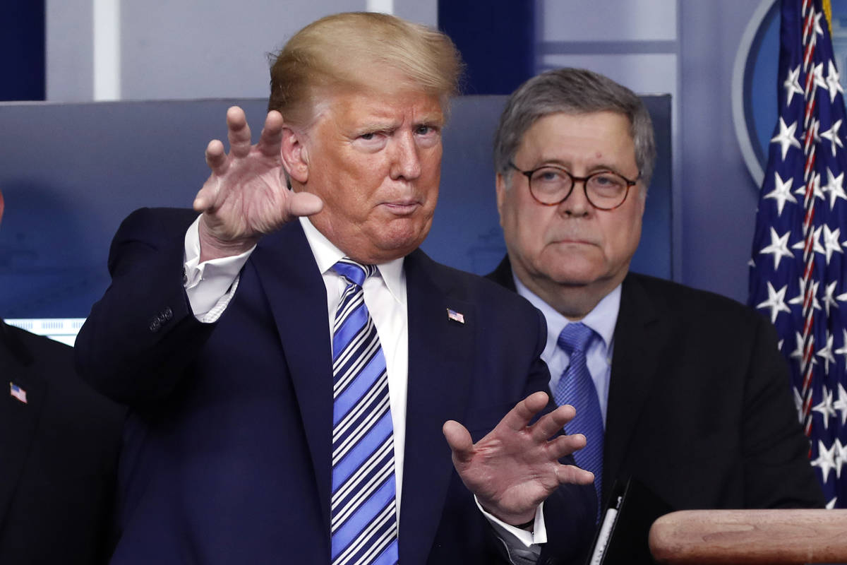 President Donald Trump is seen in March 2020 with Attorney General William Barr. (AP Photo/Alex ...