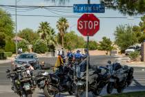 A Major Crash Investigation Unit records the scene of a downed motorcycle and car collision as ...