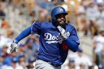 Los Angeles Dodgers' Andrew Toles runs to first during the second nning of a spring training ba ...