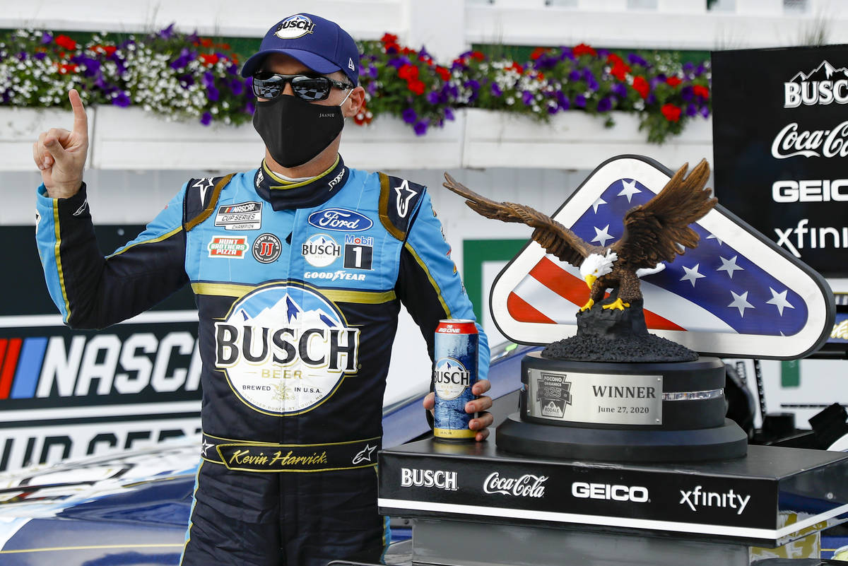 Kevin Harvick celebrates in the winners circle after winning the NASCAR Cup Series auto race at ...