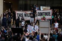 Protesters demonstrate in front of the Hall of Justice building to protest the deaths of George ...