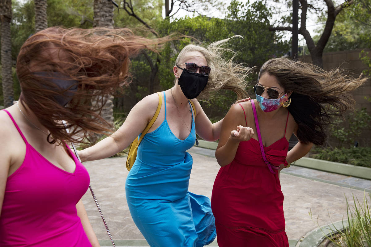 Ashten Majors, from left, Angela Wetzel, and Brandi Ayala, all of Houston, withstand strong win ...