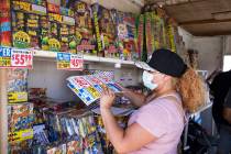 Chantal Roybao organizes fireworks for sale at a stand on Maryland Parkway in Las Vegas, Sunday ...