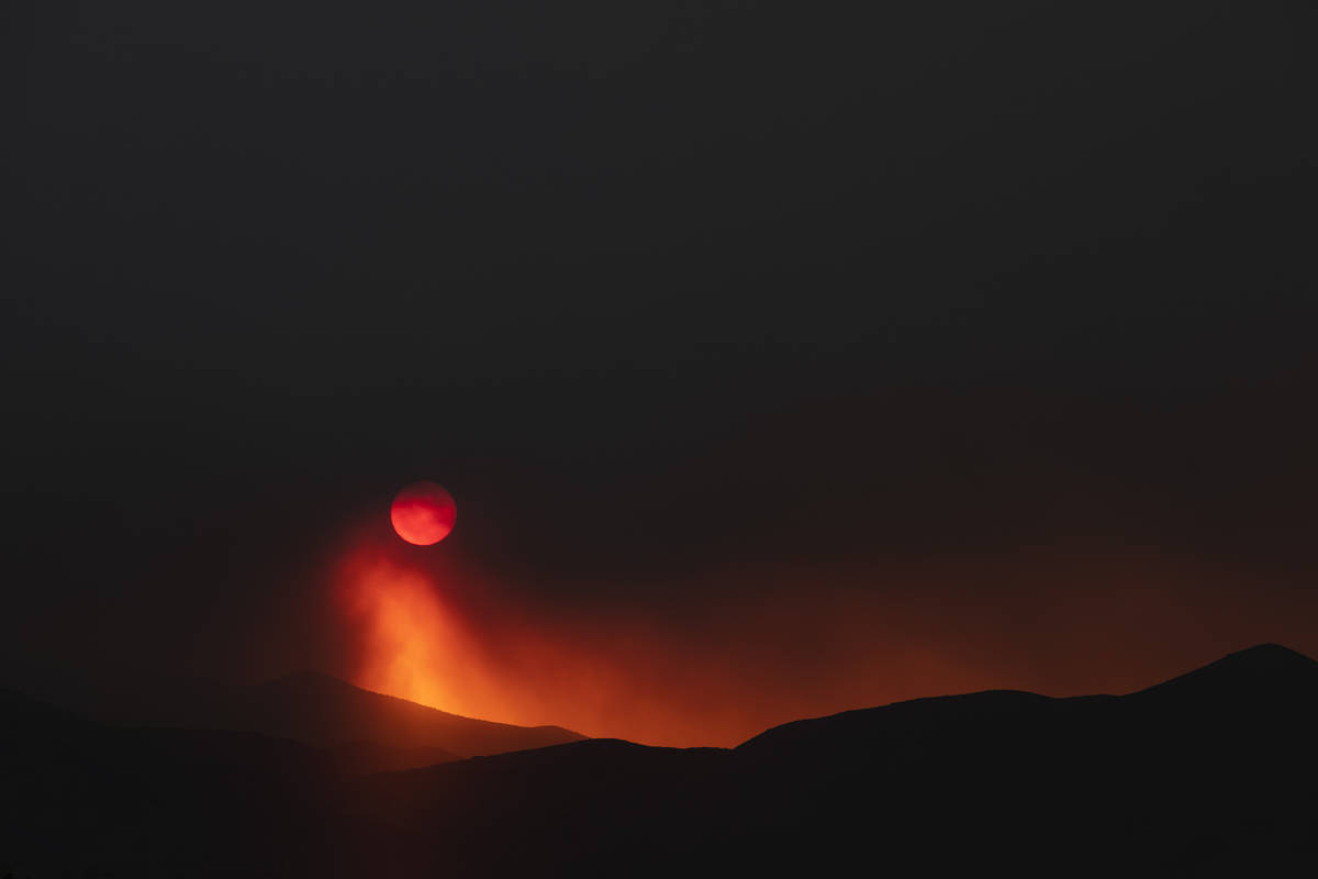 Smoke from the Mahogany Fire dims the sun as it sets at Mount Charleston on Sunday, June 28, 20 ...