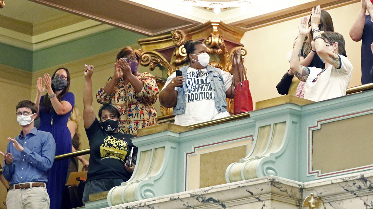 Members of the Mississippi Senate gallery rise and applaud after the body passed a resolution t ...