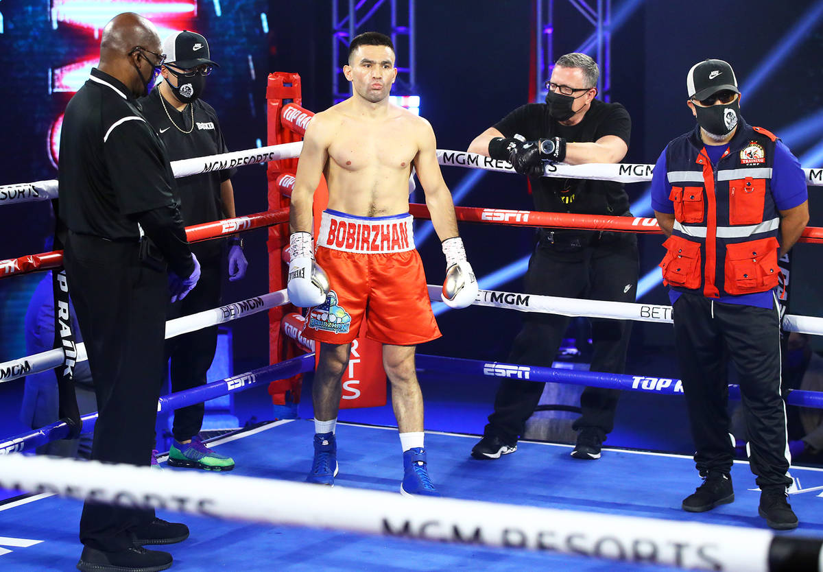 Boxer Bobirzhan Mominov is shown with his cornermen, including cutman Mike Bazzel, during a rec ...