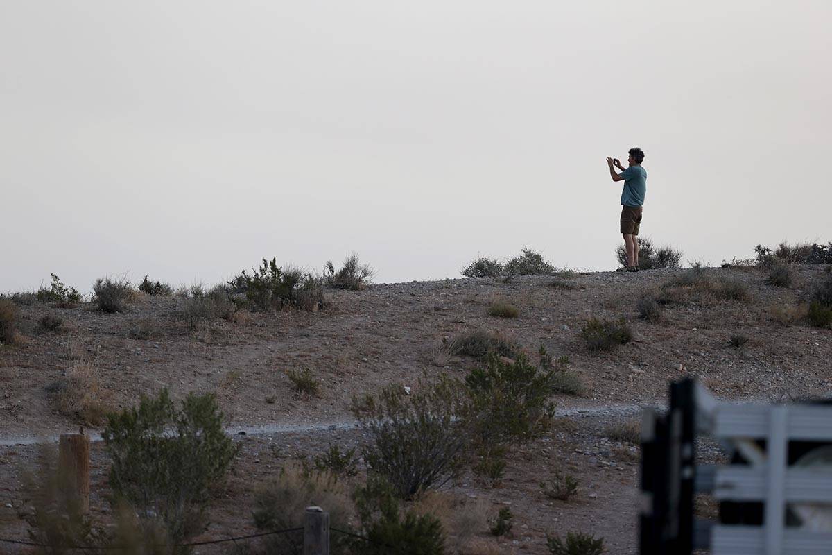 A spectator takes a photo of the Mahogany Fire on Mount Charleston near Las Vegas on Monday, Ju ...