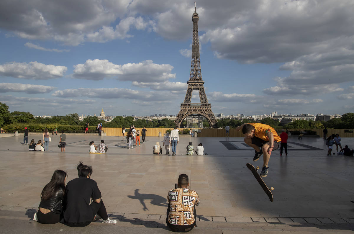 In a Monday, May 25, 2020, file photo, people stroll at Trocadero square near the Eiffel Tower ...