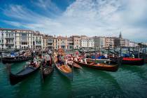 In a Sunday, June 21, 2020, file photo, gondolas are lined up during the Vogada della Rinascita ...