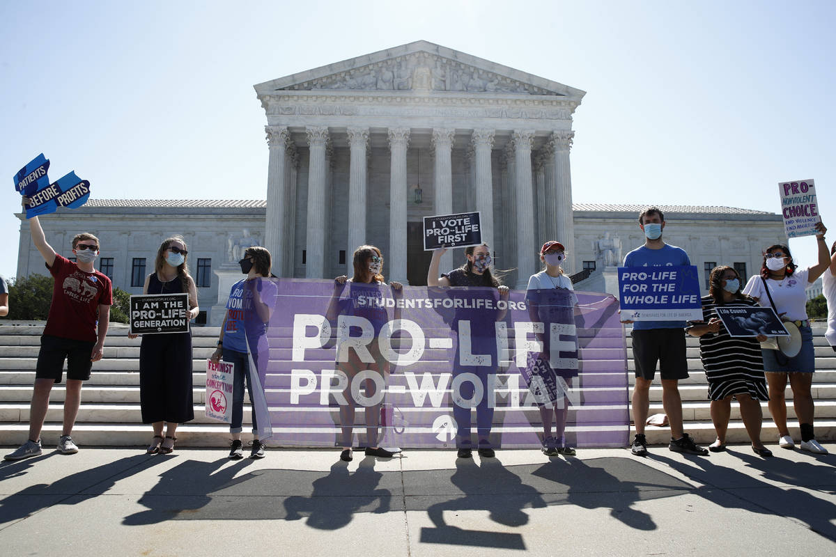 Anti-abortion protesters wait outside the Supreme Court for a decision, Monday, June 29, 2020 i ...