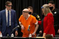 Joseph James DeAngelo, center, charged with being the Golden State Killer, is helped up by his ...
