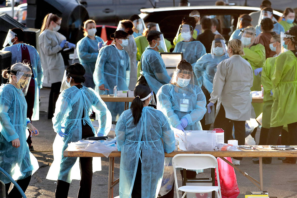 In this photo taken Saturday, June 27, 2020, medical personnel prepare to test hundreds of peop ...