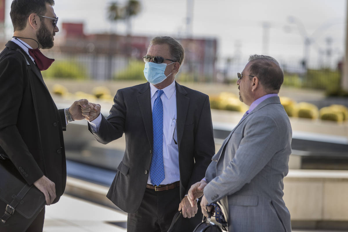 Attorney Andrew Marcantel, left, greets Douglas Haig with attorney Marc Victor as they arrive f ...