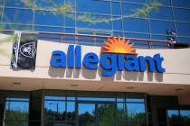 A Raiders flag hangs in front of the Allegiant headquarters in Las Vegas, Monday, Aug. 5, 2019. ...