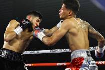 Junior welterweight Alex Saucedo makes contact against Sonny Fredrickson on Tuesday night at th ...