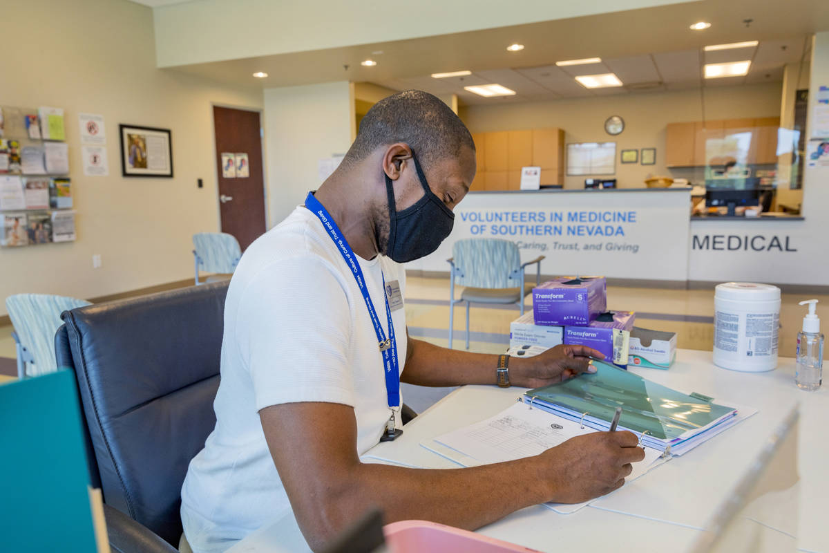 Volunteer specialist Tommy Thompson completes check outs at the Volunteers in Medicine of South ...