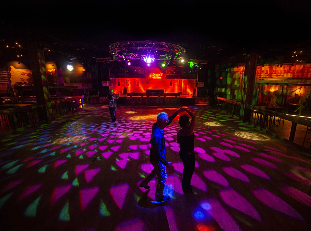 Chau Lam, middle, dances with wife Cindy while adhering to social distancing standards at Stone ...