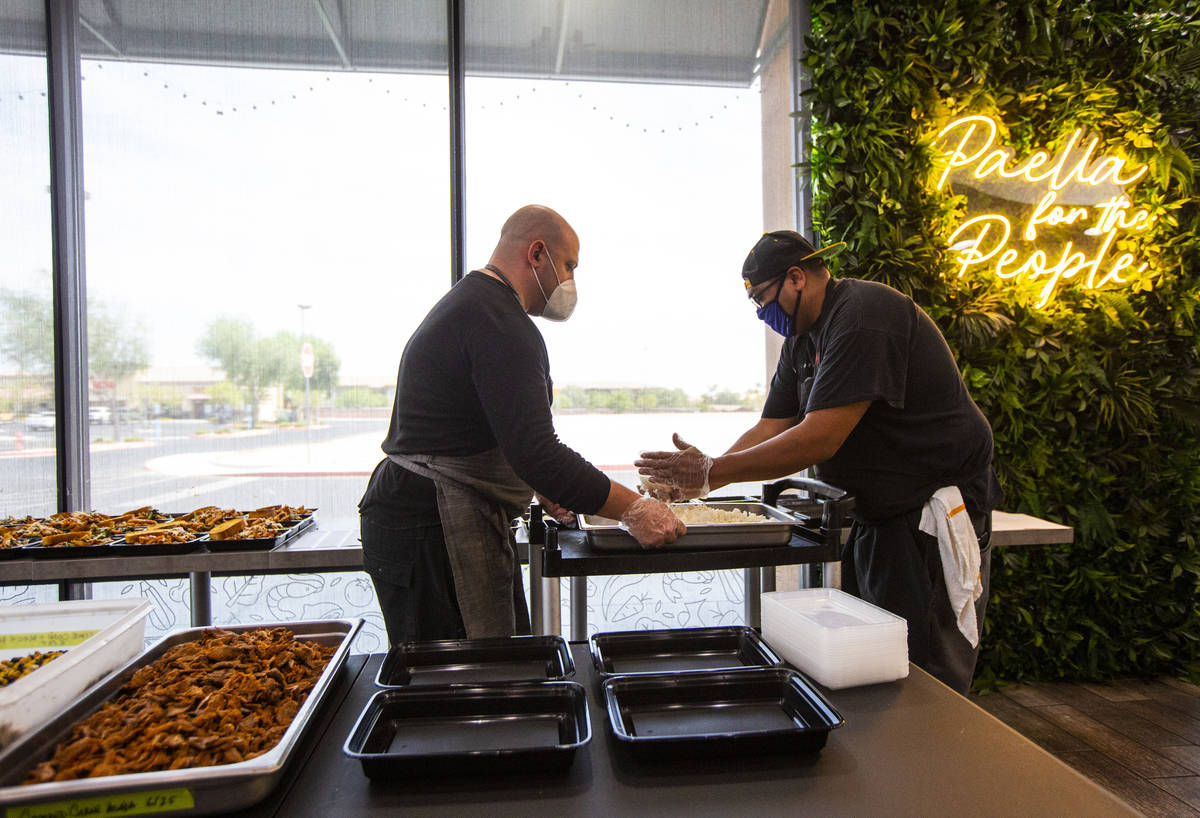Jeffrey Weiss, left, and Paras Shah, co-owners and co-chefs at Valencian Gold, package meals fo ...