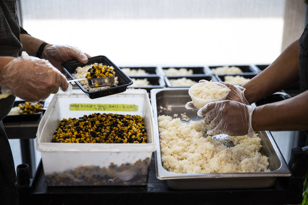 Jeffrey Weiss, left, and Paras Shah, co-owners and co-chefs at Valencian Gold, package meals fo ...