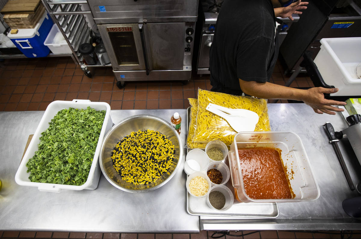 Paras Shah, co-owner and co-chef at Valencian Gold, gets ready to prepare meals for Delivering ...