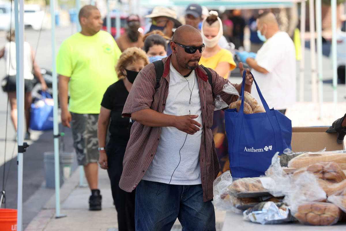 Joaquin Valdez, who said he is homeless in Las Vegas, picks up a food bag at SHARE Village, for ...