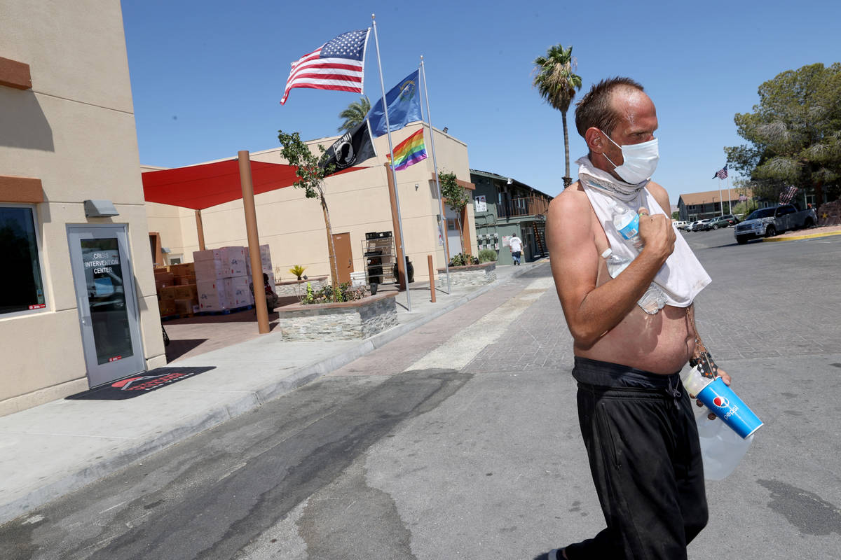 Eric Michael Wynn, 53, walks back to his camp after getting water in the front office at SHARE ...