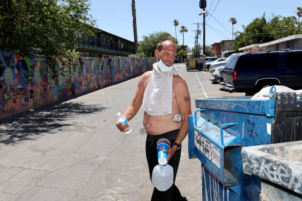 Eric Michael Wynn, 53, walks back to his camp after getting water in the front office at SHARE ...