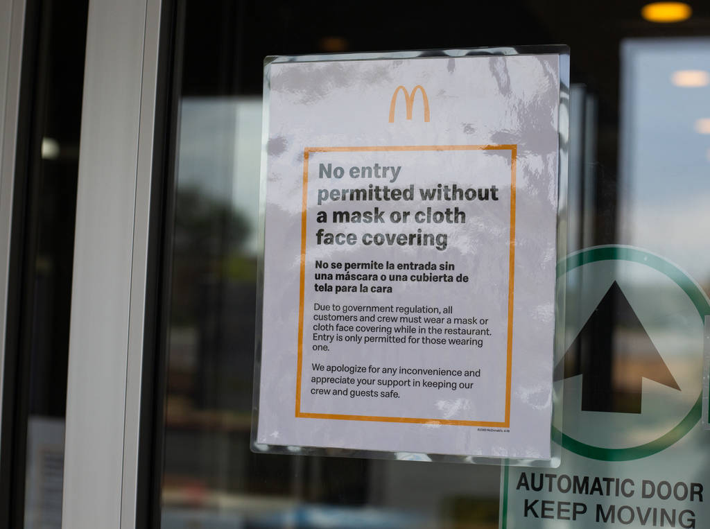 A sign at McDonald's states that masks are required to enter in Las Vegas on Friday, June 26, 2 ...