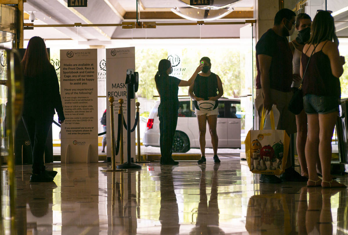 A man stops stop for a temperature check at tthe Westgate in Las Vegas on Saturday, June 27, 20 ...