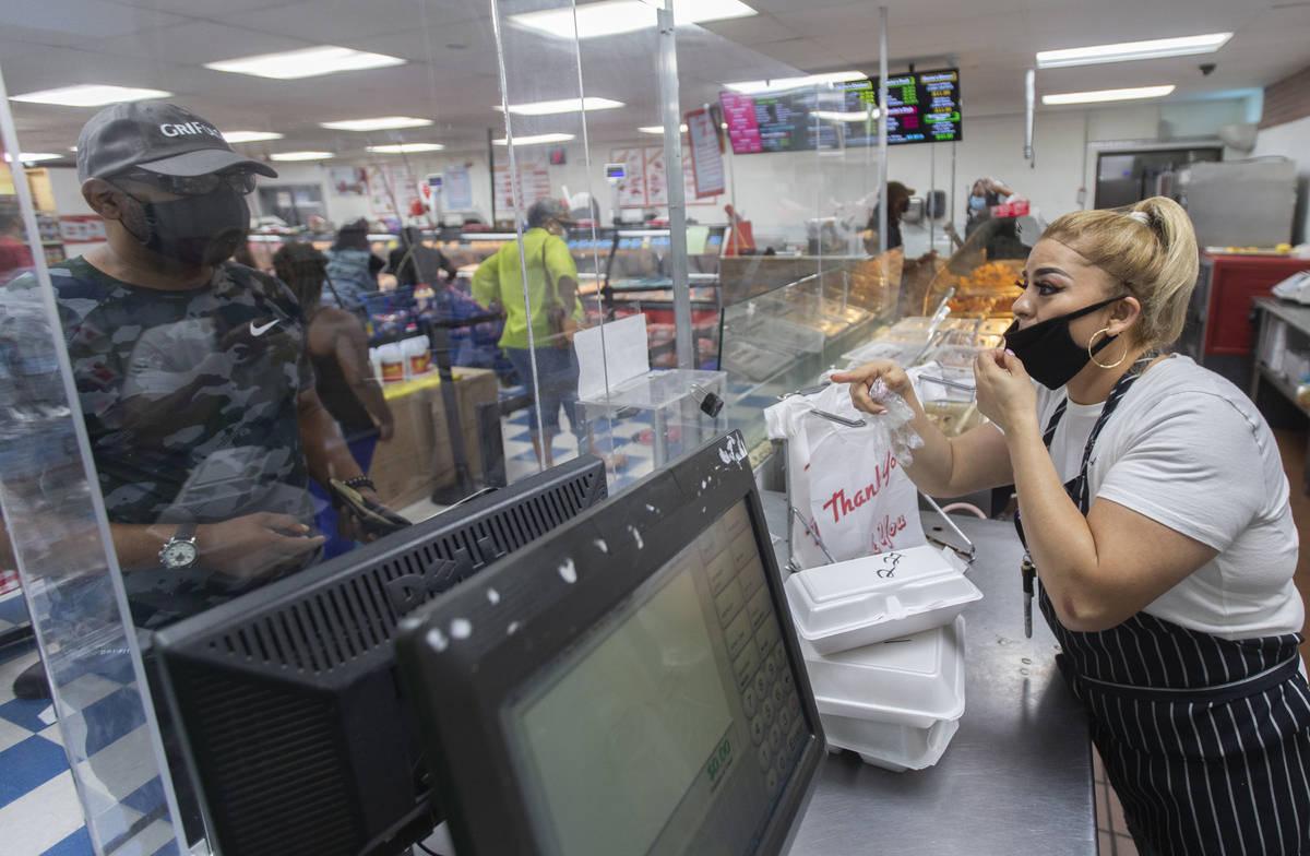 Hot food server Shelley Portillo, right, takes an order at Mario's Westside Market on Wednesday ...