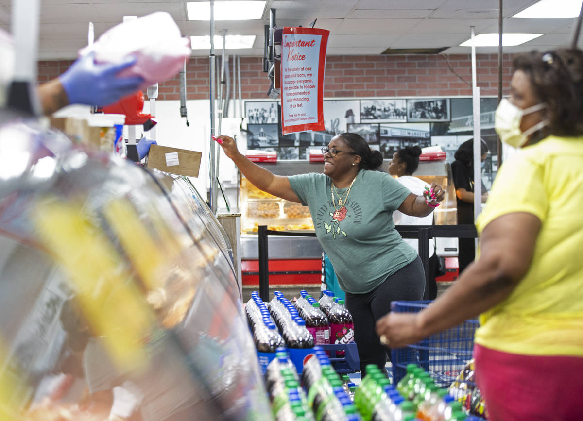 Teresea High, top/left, grabs a ticket at the deli at Mario's Westside Market on Wednesday, Jun ...