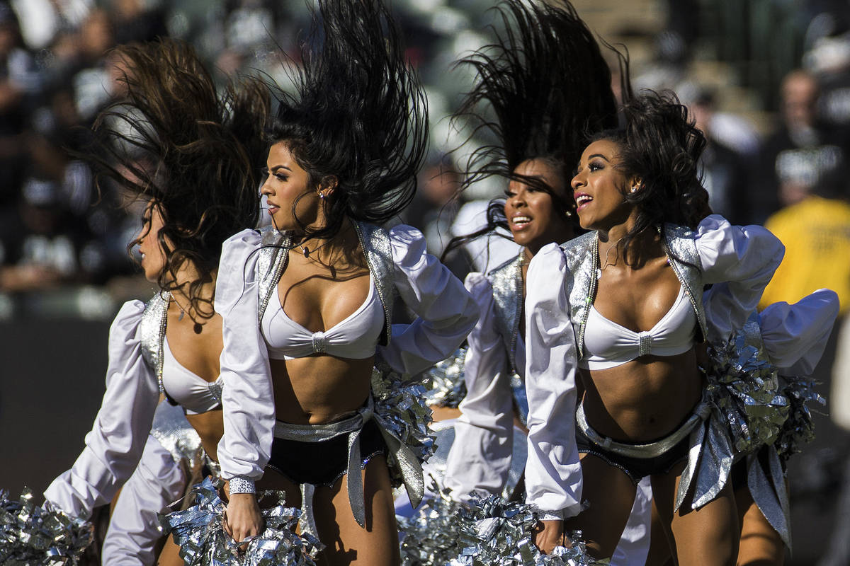 The Raiderettes perform during a break in the first quarter of an NFL footb...