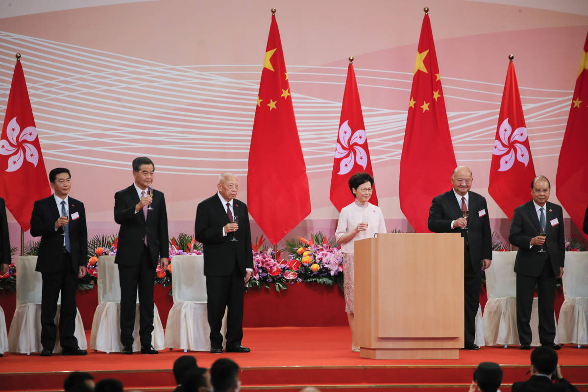 Hong Kong's Chief Executive Carrie Lam, center, toasts with guests following the flag-raising c ...