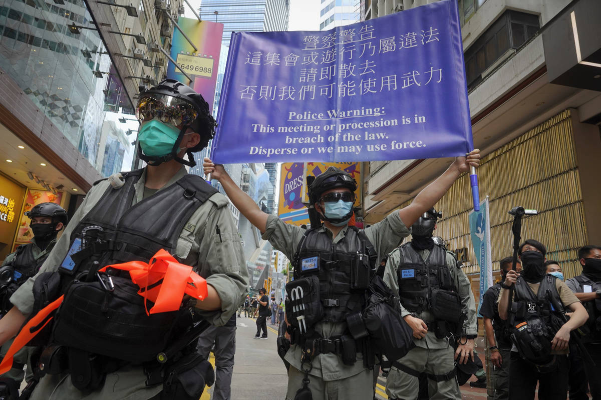 Police display a public announcement banner showing the warning to protesters in Causeway Bay b ...