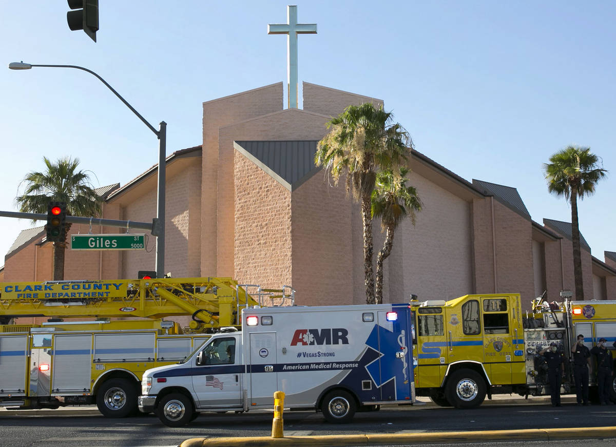 An ambulance carrying a wounded Las Vegas police officer Shay Mikalonis drives past Shrine of T ...