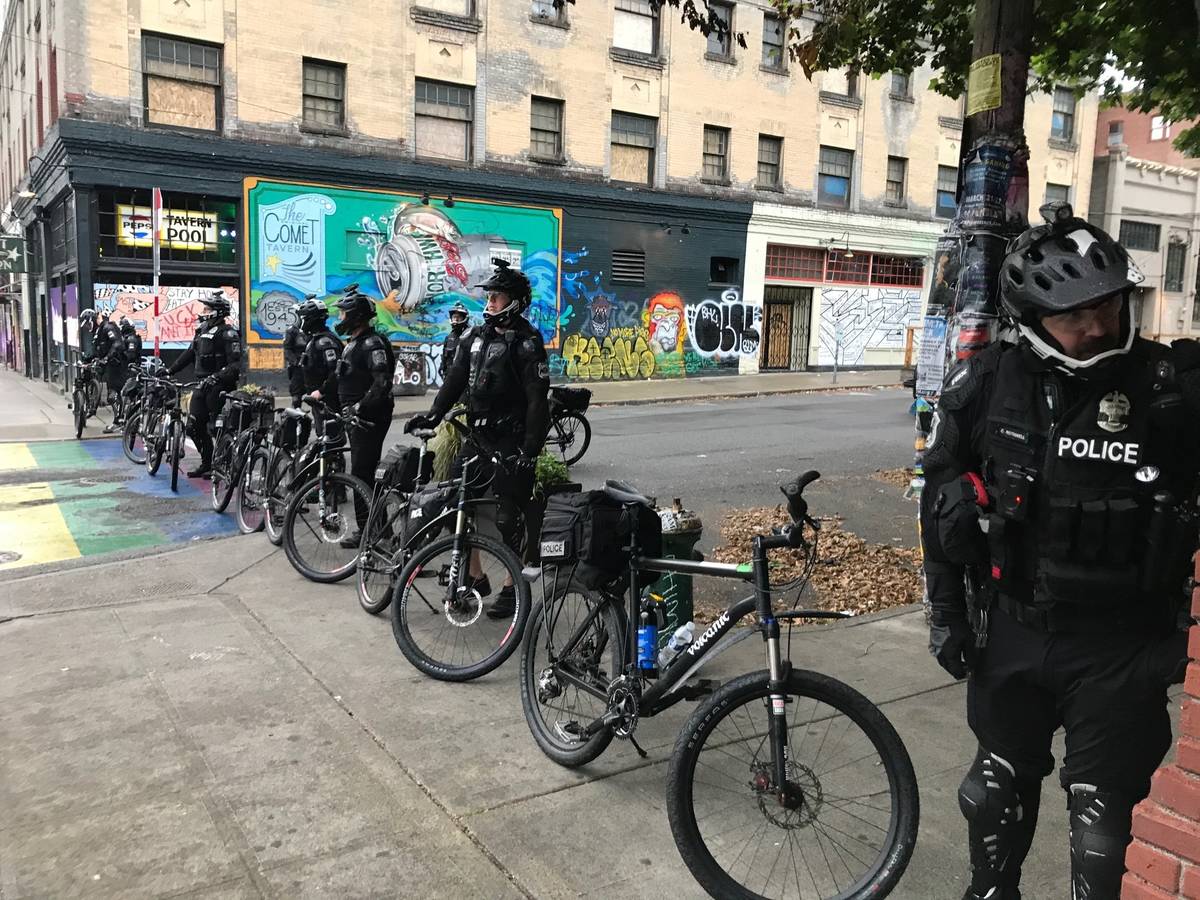 Seattle police block a street with their bicycles in the Capitol Hill Organized Protest zone ea ...