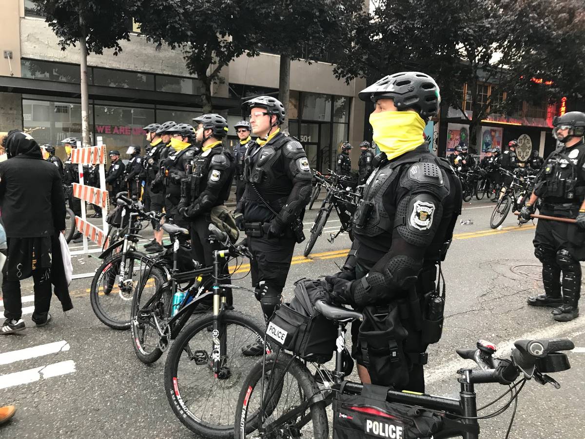 Seattle police block a street with their bikes in the Capitol Hill Organized Protest zone early ...