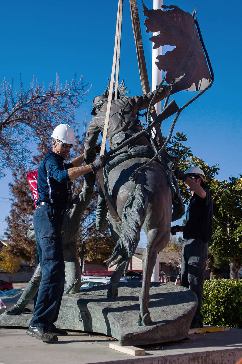 In this Dec. 6, 2012, file photo, workers remove a statue depicting two Confederate soldiers, i ...