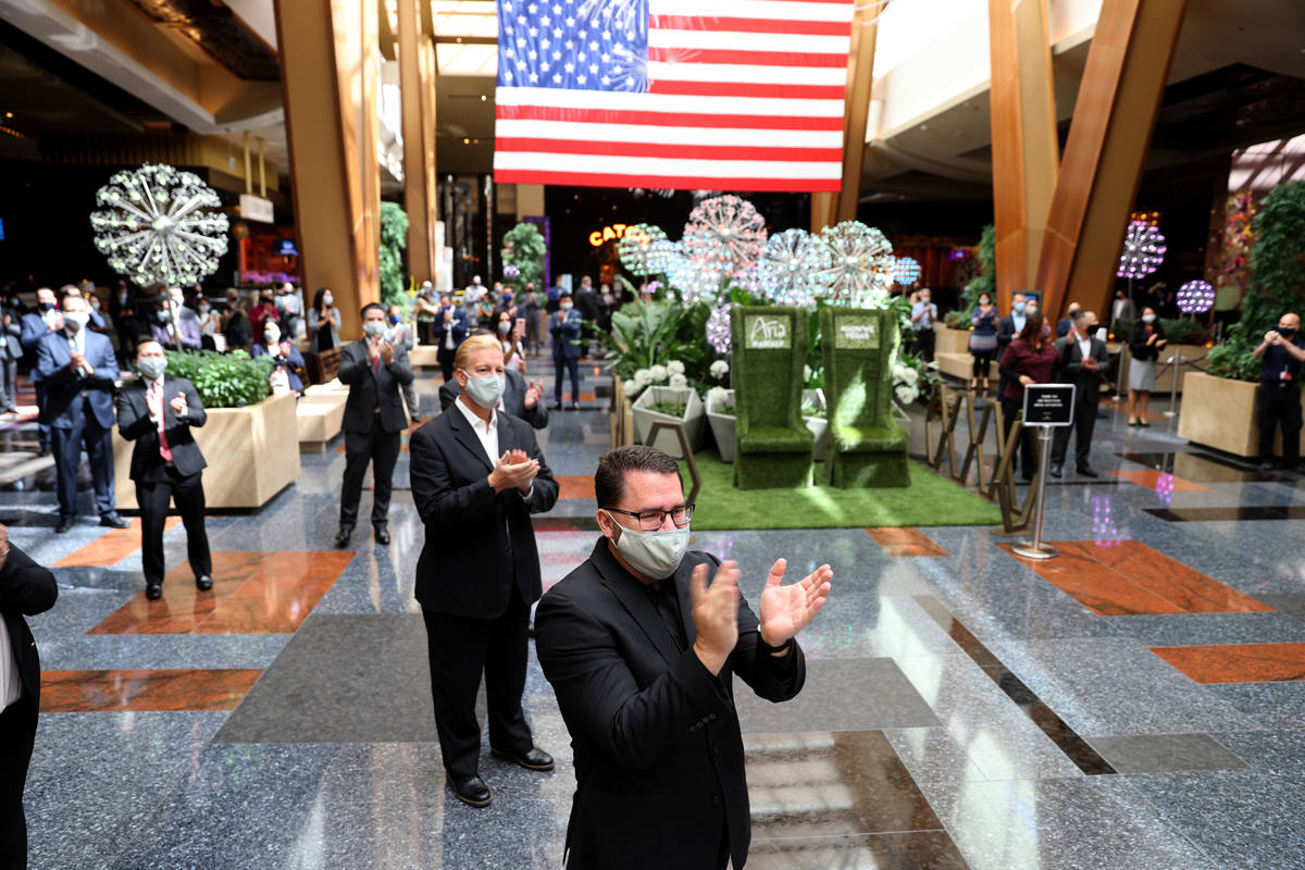 Aria employees, including Assistant Director of Catering Woody Saulter, applaud guests upon reo ...