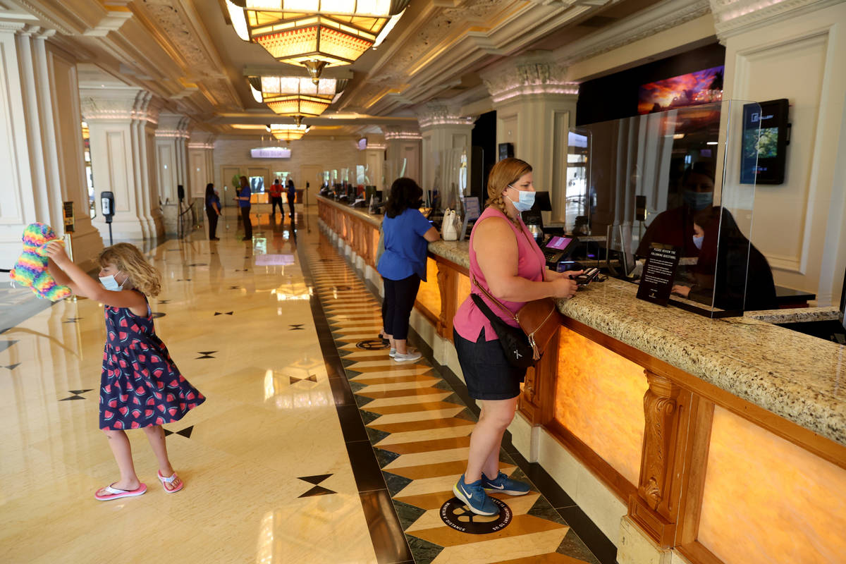 Christine Folkes and her daughter Sierra, 7, of Sacramento, Calif. check in Mandalay Bay on the ...