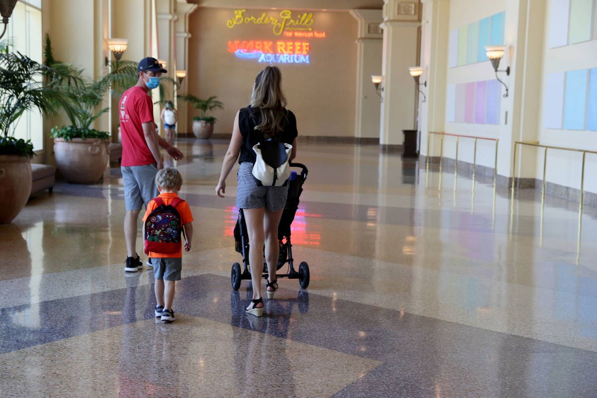 Guests walk to Shark Reef in Mandalay Bay on the Strip in Las Vegas upon reopening Wednesday, J ...