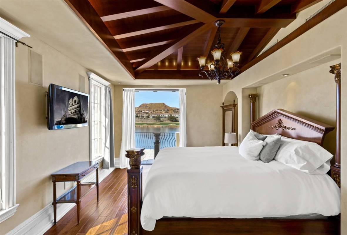 The main bedroom suite offers views of Lake Las Vegas and has a has an outdoor patio that wraps ...