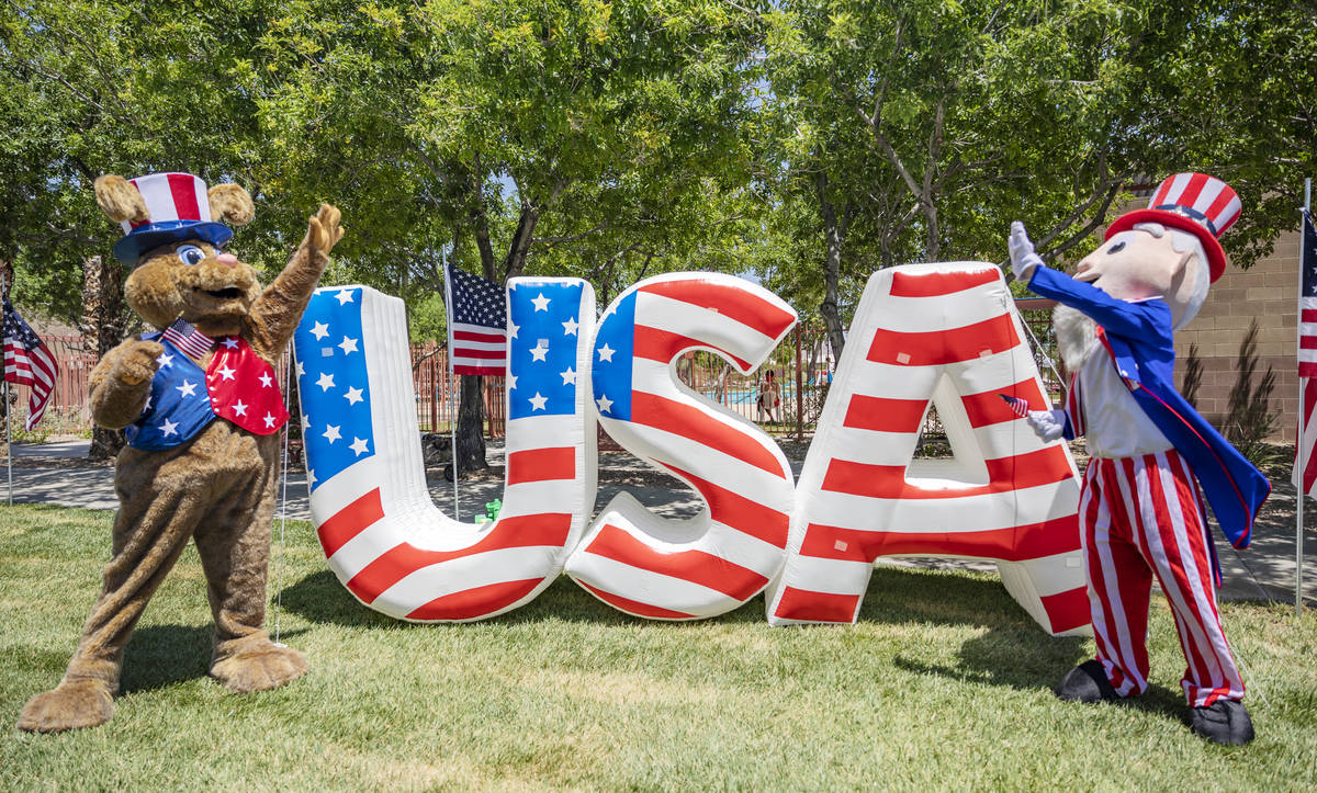 Summerlin Sam and Uncle Sam high-five during a preview of the virtual Summerlin Council Patriot ...