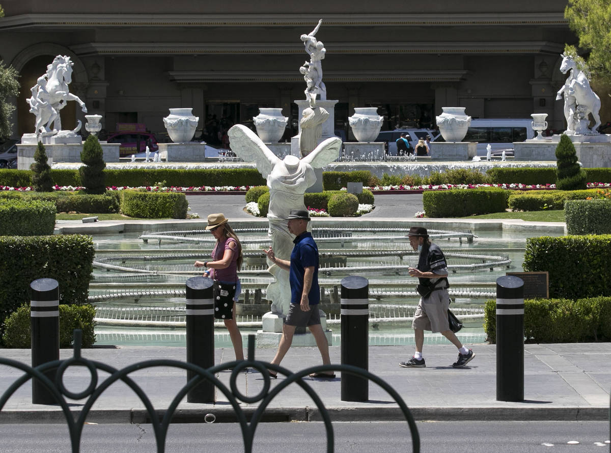 Tourists walk past Caesars Palace fountains on Friday, July 3, 2020, in Las Vegas. (Bizuayehu T ...