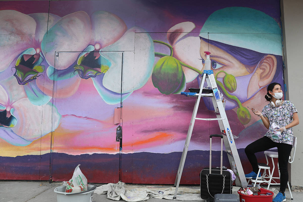 Muralist and staff of Priscilla Fowler Fine Art, Chelsea Rust, paints a mural of a Las Vegas Va ...
